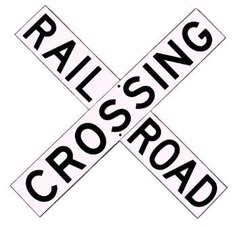 Railroad crossing buck signs are posted at every railroad, highway, road, or street grade crossing and shows the location. (shows number of tracks crossed.)