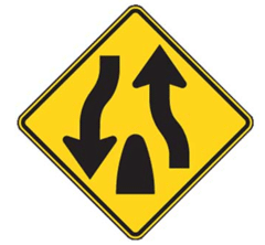 The divided highway on which you are traveling ends ahead