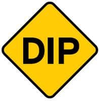 There is a dip in the road ahead. Slow down