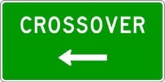 This sign marks a place where you may cross over to the other side of the divided highway.