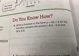 Write a function in the form y = mx + b for the line that contains the points (−8.3, −5.2) and (6.4, 9.5)